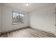 Simple bedroom with wood-look floors and a window at 115 Beauview Way, Zebulon, NC 27597