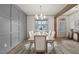 Bright dining room with gray wall paneling, hardwood floors, and a large window at 115 Beauview Way, Zebulon, NC 27597