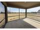 This sunroom includes a screen and a concrete floor with a view of the pasture at 48 Silver Ct, Smithfield, NC 27577