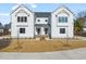 Two-story white farmhouse style duplex with stone accents and landscaping at 530 Germaine St, Apex, NC 27502