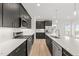 Modern kitchen with island, dark cabinets, and stainless steel appliances at 530 Germaine St, Apex, NC 27502