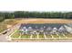 An aerial view of newly built townhomes with black roofs, neutral siding, and green lawns at 937 Alma Railway Dr # 555, Wake Forest, NC 27587