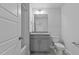 Bright bathroom with grey cabinets, granite countertop, and a toilet and shower with grey tile at 937 Alma Railway Dr # 555, Wake Forest, NC 27587
