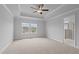 Bright bedroom featuring a tray ceiling, a ceiling fan and a view into the en-suite bathroom at 937 Alma Railway Dr # 555, Wake Forest, NC 27587
