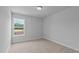 Bright bedroom with a window letting in natural light and plush beige carpeting at 937 Alma Railway Dr # 555, Wake Forest, NC 27587