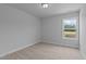 A bright and well-lit bedroom with neutral walls and carpet, complemented by a window offering a scenic view at 937 Alma Railway Dr # 555, Wake Forest, NC 27587