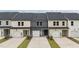 New construction townhomes with driveways and garages, and a combination of siding colors at 937 Alma Railway Dr # 555, Wake Forest, NC 27587