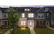 Charming townhome with a brick facade, blue door, and a well-manicured lawn at 937 Alma Railway Dr # 555, Wake Forest, NC 27587