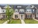Charming townhome with a brick facade, blue door, and a well-manicured lawn at 937 Alma Railway Dr # 555, Wake Forest, NC 27587