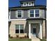 Charming two-story home with brick facade, gray siding, and a welcoming light-blue front door at 937 Alma Railway Dr # 555, Wake Forest, NC 27587