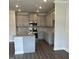 Stylish kitchen features gray cabinets, stainless steel appliances, granite countertops, and hardwood flooring at 937 Alma Railway Dr # 555, Wake Forest, NC 27587