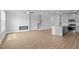Spacious living room featuring a modern fireplace and hardwood floors leading into an open kitchen and dining area at 937 Alma Railway Dr # 555, Wake Forest, NC 27587