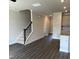 Open-concept living room features hardwood flooring, staircase, and seamless transition to the kitchen at 937 Alma Railway Dr # 555, Wake Forest, NC 27587