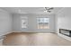 Bright living room with modern fireplace, ceiling fan, and natural light at 937 Alma Railway Dr # 555, Wake Forest, NC 27587