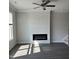 Living area showcases a modern electric fireplace, hardwood floors, and natural light from a large window at 937 Alma Railway Dr # 555, Wake Forest, NC 27587