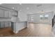 Open floor plan with gray cabinets, granite countertops, stainless steel appliances at 937 Alma Railway Dr # 555, Wake Forest, NC 27587