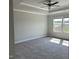 Spacious main bedroom features plush carpeting, a tray ceiling with fan, and natural light from windows at 937 Alma Railway Dr # 555, Wake Forest, NC 27587