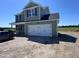 Charming two-story home with a two car garage, green siding, black shutters, and a well-manicured front yard at 195 Sawyer Mill Dr, Dunn, NC 28334