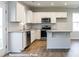 Bright kitchen featuring white cabinets, stainless steel appliances, granite countertops, and a stylish island at 195 Sawyer Mill Dr, Dunn, NC 28334