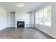 Spacious living room featuring a fireplace, built in shelves, and large windows offering plenty of natural light at 195 Sawyer Mill Dr, Dunn, NC 28334