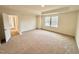 Spacious bedroom with carpet and access to hallway at 99 Baird Cove Ln # 173, Angier, NC 27501