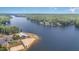 Beautiful aerial view of a lake, shoreline, beach and recreational area with trees and clear skies reflected in the water at 143 Rawhide Dr, Louisburg, NC 27549