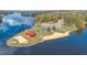 Picturesque aerial view of a lake, showcasing a beach, volleyball court, parking, and lake side views at 143 Rawhide Dr, Louisburg, NC 27549