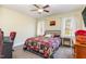 Comfortable bedroom with a black metal bed frame, two windows and a ceiling fan at 143 Rawhide Dr, Louisburg, NC 27549