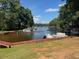 Scenic view of a boat dock with multiple boats docked, surrounded by trees at 143 Rawhide Dr, Louisburg, NC 27549