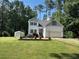 Charming two-story home with well-manicured lawn and front garden at 143 Rawhide Dr, Louisburg, NC 27549