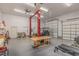 Spacious garage with a car lift, work table, storage shelves, and room for parking at 143 Rawhide Dr, Louisburg, NC 27549