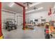 Spacious garage with two-car lift, golf cart, exercise equipment, storage, and tool bench at 143 Rawhide Dr, Louisburg, NC 27549