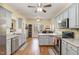 Eat-in kitchen with grey cabinets, granite countertops, stainless appliances and hardwood floors at 143 Rawhide Dr, Louisburg, NC 27549