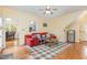The living room features hardwood floors, a pass through to the kitchen and a red leather sofa at 143 Rawhide Dr, Louisburg, NC 27549
