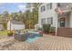 A charming outdoor brick patio features a cozy seating arrangement, ideal for relaxation and entertaining at 143 Rawhide Dr, Louisburg, NC 27549