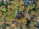 House nestled in a wooded neighborhood with fall foliage at 2600 Wade Ave, Raleigh, NC 27607