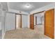 Finished basement bedroom with carpet flooring and access to other rooms at 2600 Wade Ave, Raleigh, NC 27607