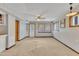 Spacious basement room with neutral walls and carpet, featuring multiple windows and a ceiling fan at 2600 Wade Ave, Raleigh, NC 27607