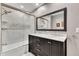 Bathroom with marble-tiled shower, double vanity, and large mirror at 2600 Wade Ave, Raleigh, NC 27607