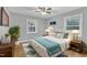 Main bedroom with hardwood floors, ceiling fan, and stylish decor at 2600 Wade Ave, Raleigh, NC 27607