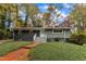 Ranch home with gray siding, brick walkway, and landscaped lawn at 2600 Wade Ave, Raleigh, NC 27607