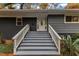 Steps leading to a white front door with sidelights and a white railing at 2600 Wade Ave, Raleigh, NC 27607