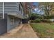 Side view of a dark gray house with a patio and steps leading to the yard at 2600 Wade Ave, Raleigh, NC 27607