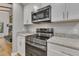 Modern kitchen with stainless steel range and microwave, granite countertops at 2600 Wade Ave, Raleigh, NC 27607