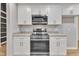 Stainless steel appliances and white cabinets in this updated kitchen at 2600 Wade Ave, Raleigh, NC 27607