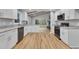 Modern kitchen with white cabinets, granite counters, and stainless steel appliances at 2600 Wade Ave, Raleigh, NC 27607