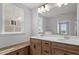 Bright bathroom featuring double vanity with undermount sinks, light wood cabinets, and a soaking tub under a window at 276 White Oak Garden Way # 210, Garner, NC 27529