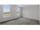 Bright bedroom with plush carpet, neutral walls, and two large windows offering natural light at 276 White Oak Garden Way # 210, Garner, NC 27529