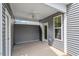Relaxing covered porch with vinyl siding, ceiling fan and access to the outdoors at 276 White Oak Garden Way # 210, Garner, NC 27529