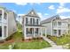 Inviting two-story home with gray siding, a classic front porch, and manicured landscaping at 276 White Oak Garden Way # 210, Garner, NC 27529